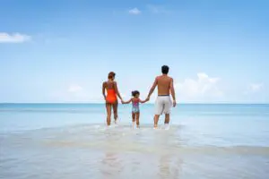 Family walking into the ocean together