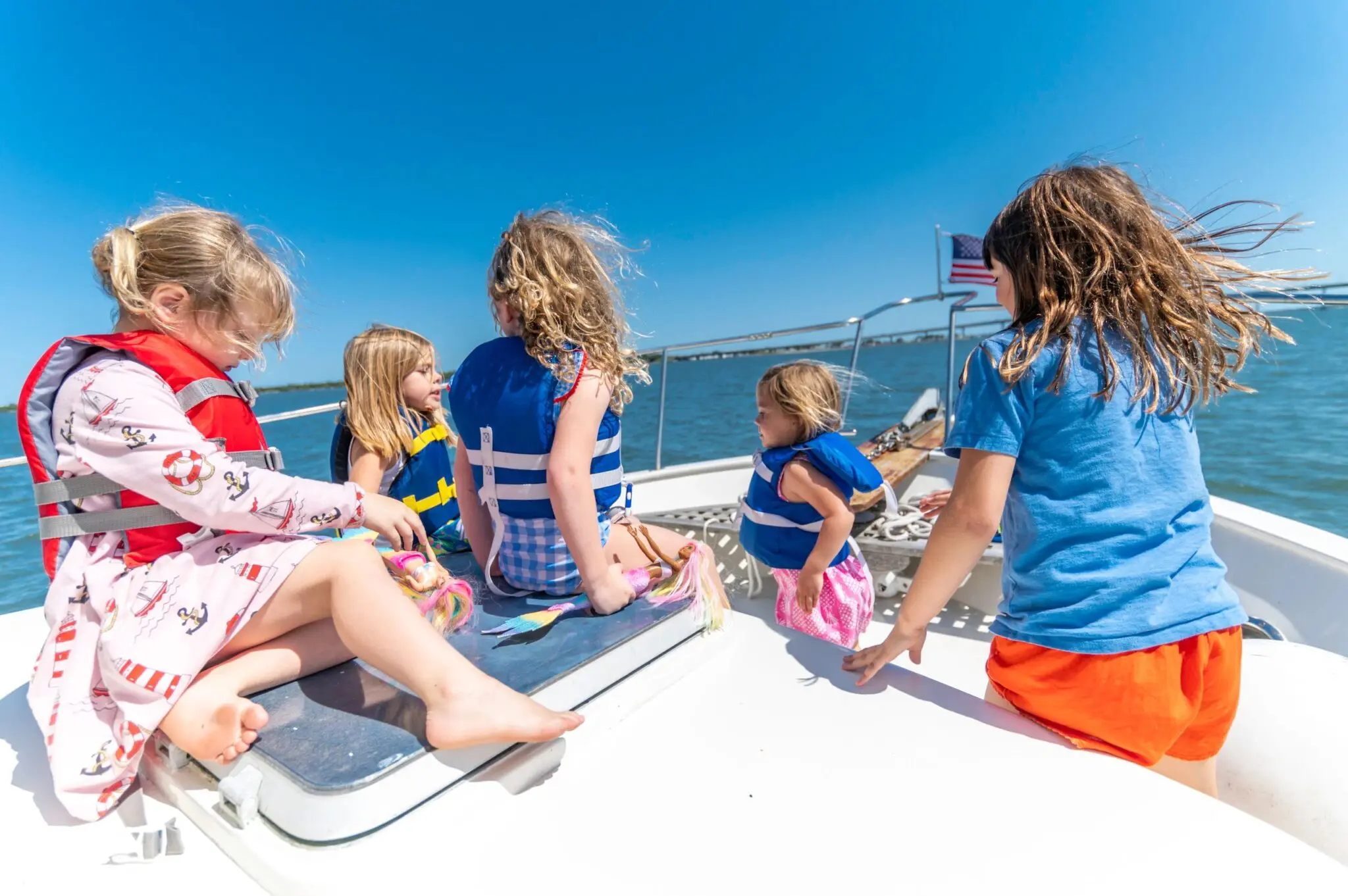 Children enjoying a sunny day on boat