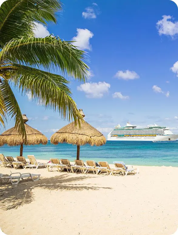 Palm trees and straw umbrellas on sandy beach