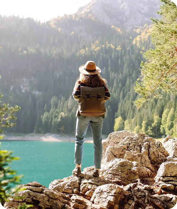 Person overlooking lake and mountains