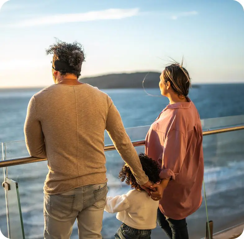 Parents and child overlooking sea