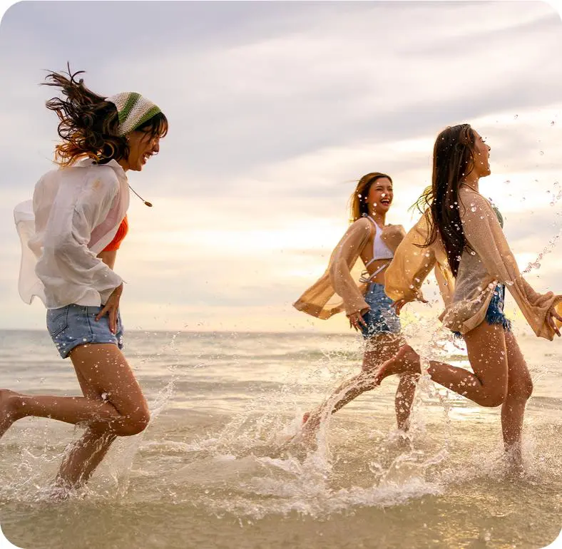 Friends enjoying sunset beach splash