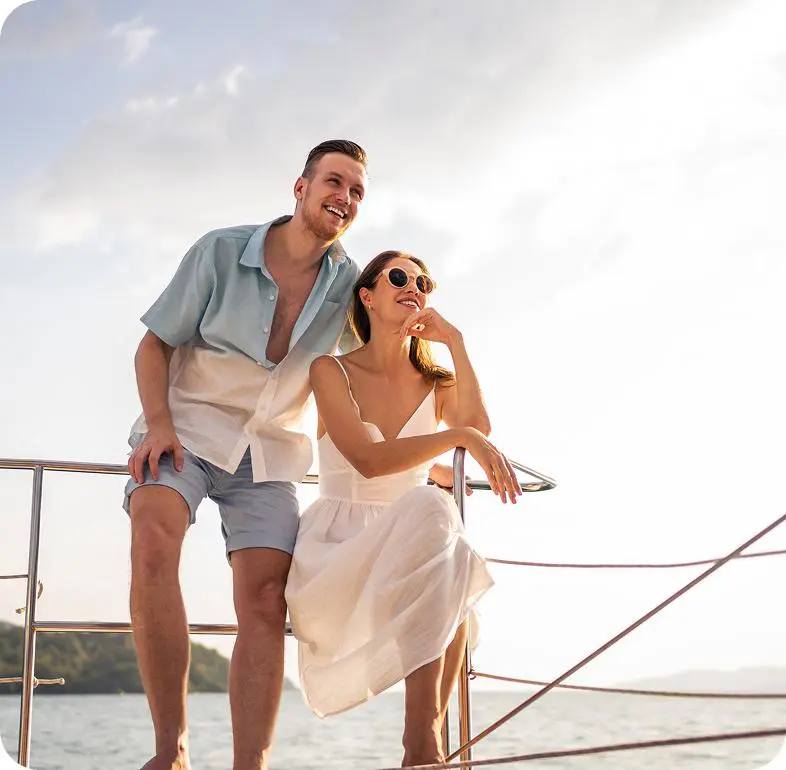 Smiling duo relaxing on sailboat